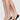 Närbild på fyra fötter i Swedish Stockings svarta steps strumpor.