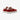 Ett par veganska MoEa GEN 9 Apple Red & Pink Suede sneakers. Skorna har en intensivt röd mockaöverdel med perforeringar över tån för ventilation. Kontrasterande vita detaljer framträder längs sidan och vid snörningen, vita, breda skosnörena.Skons plös är vit med  en vit etikett med varumärkets namn i svart text, rosa hälkappa. Sulorna är vita med en lätt texturerad yta. Fotograferade snett bakifrån med fokus på hälkappan. 