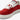 En detaljbild på en vegansk MoEa GEN 9 Apple Red & Pink Suede sneaker. Skon har en intensivt röd mockaöverdel med perforeringar över tån för ventilation. Kontrasterande vita detaljer framträder längs sidan och vid snörningen, vita, breda skosnörena.Skons plös är vit med  en vit etikett med varumärkets namn i svart text, rosa hälkappa. Sulan är vit med en lätt texturerad yta. Bilden är fokuserad mest på skons snörning. 