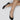 Närbild på fötter uppifrån i Swedish Stockings svarta steps strumpor.